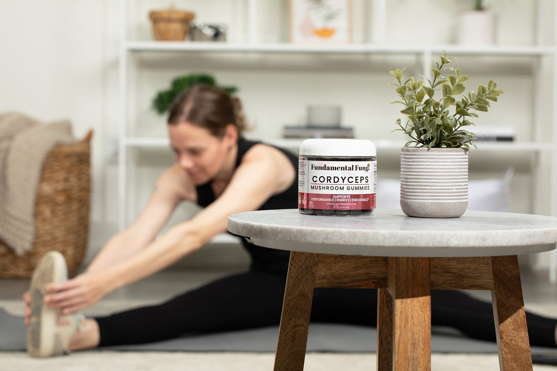 Cordyceps mushroom gummies next to a stretching routine on a workout mat