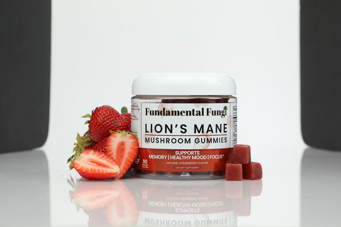 Lion's Mane mushroom gummies bottle with strawberries on a studio background