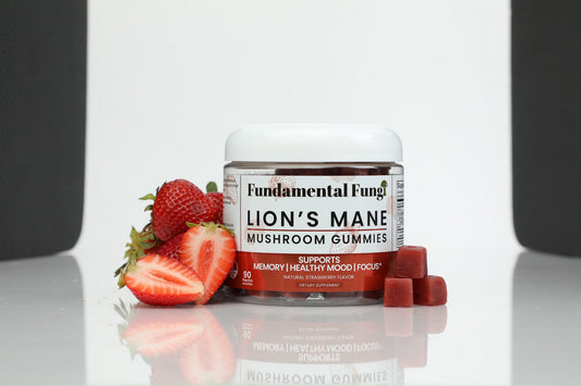 Lion's Mane mushroom gummies bottle with strawberries on a studio background