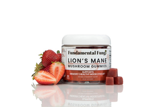 Lion's Mane mushroom gummies bottle with fresh strawberries
